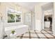 A bathtub and glass shower are featured in this well-lit bathroom at 12217 Tempestad Ave, Las Vegas, NV 89138