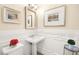 This half bathroom has bright white wainscotting and walls, along with attractive wall decor at 12217 Tempestad Ave, Las Vegas, NV 89138