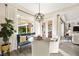Bright breakfast nook featuring a stylish chandelier, comfortable seating, and large windows overlooking the backyard at 12217 Tempestad Ave, Las Vegas, NV 89138