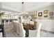 Elegant dining room with modern lighting, decorative wall art, and a seamless transition to the adjacent kitchen at 12217 Tempestad Ave, Las Vegas, NV 89138