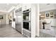 Kitchen featuring stainless steel appliances, including a double oven and large refrigerator, with open access to the dining area at 12217 Tempestad Ave, Las Vegas, NV 89138