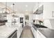 Bright kitchen featuring white cabinets, stainless steel appliances, and stylish pendant lighting at 12217 Tempestad Ave, Las Vegas, NV 89138