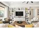 Cozy living room with custom built-in shelves, a modern TV, and comfortable seating arrangements at 12217 Tempestad Ave, Las Vegas, NV 89138