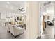 Bright open-concept living and kitchen area with wood-style flooring and tons of seating at 12217 Tempestad Ave, Las Vegas, NV 89138
