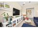 Living room featuring built-ins, shelving, and a ceiling fan at 12217 Tempestad Ave, Las Vegas, NV 89138
