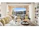 View from a living room to an outdoor space with dining and seating, providing seamless indoor-outdoor living at 12217 Tempestad Ave, Las Vegas, NV 89138