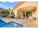 Relaxing patio area with comfortable seating beside the pool, perfect for outdoor lounging and relaxation at 12217 Tempestad Ave, Las Vegas, NV 89138