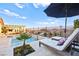 Backyard featuring a private pool, lounge chairs, landscaped surroundings, and clear blue skies above at 12217 Tempestad Ave, Las Vegas, NV 89138