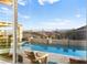 Inviting pool with a raised stone feature wall and views to the city at 12217 Tempestad Ave, Las Vegas, NV 89138