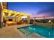 Backyard oasis featuring sparkling pool, spa, and outdoor kitchen at 12217 Tempestad Ave, Las Vegas, NV 89138