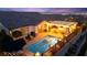 Outdoor oasis features a pool, covered patio with dining area, and fire features for cozy evenings at 12217 Tempestad Ave, Las Vegas, NV 89138