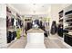 Spacious walk-in closet with custom shelving, an island, and hanging racks for ample storage at 12217 Tempestad Ave, Las Vegas, NV 89138