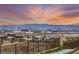 Scenic aerial view showcases the city skyline, mountains, and desert landscape beyond modern home at 12648 Heritage Bend Dr, Las Vegas, NV 89138