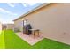 Outdoor space boasts artificial turf, brick patio, and BBQ area, perfect for entertaining at 12648 Heritage Bend Dr, Las Vegas, NV 89138