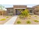 Charming single-story home featuring desert landscaping, stone accents, and a modern front door at 12648 Heritage Bend Dr, Las Vegas, NV 89138