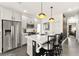 Kitchen features a quartz countertop island, white cabinets, stainless steel appliances and black dining chairs at 12648 Heritage Bend Dr, Las Vegas, NV 89138