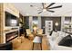 Inviting living room boasts a fireplace, large ceiling fan, neutral color scheme, and bright natural light at 12648 Heritage Bend Dr, Las Vegas, NV 89138