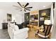 Cozy living room featuring a modern fireplace with a mounted television and a large ceiling fan at 12648 Heritage Bend Dr, Las Vegas, NV 89138