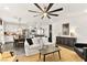 Comfortable living room showcases an open floor plan with eat-in kitchen, white sofa, ceiling fan and stylish decor at 12648 Heritage Bend Dr, Las Vegas, NV 89138