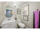 Fun powder room features colorful splatter wallpaper and a white vanity with decorative wall art at 150 Las Vegas Blvd # 1507, Las Vegas, NV 89101
