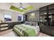 Modern bedroom features a green accent ceiling, stylish wallpaper, and closet space with a city view at 150 Las Vegas Blvd # 1507, Las Vegas, NV 89101