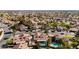 Aerial view featuring a kidney-shaped pool in a residential neighborhood with tree-lined streets at 1528 Tonada Way, Las Vegas, NV 89117