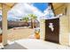 Charming backyard with desert landscaping, a decorative gate, and a view from a covered patio at 1528 Tonada Way, Las Vegas, NV 89117