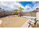 Well-maintained backyard with desert landscaping, mature palm trees, and comfortable seating for outdoor enjoyment at 1528 Tonada Way, Las Vegas, NV 89117