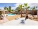 Private backyard with a sparkling pool, desert landscaping, and seating, great for relaxing and entertaining at 1528 Tonada Way, Las Vegas, NV 89117