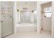 Bathroom showcasing a glass shower and soaking tub with bright natural light at 1528 Tonada Way, Las Vegas, NV 89117