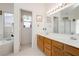 Bright bathroom with double sinks and a separate tub and shower at 1528 Tonada Way, Las Vegas, NV 89117
