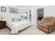Bedroom features a window, comfortable chair, and an open doorway to another room at 1528 Tonada Way, Las Vegas, NV 89117
