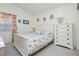 Cozy bedroom with white furniture and patterned bedding, bathed in natural light at 1528 Tonada Way, Las Vegas, NV 89117