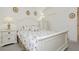 Bright bedroom with white furniture, patterned bedding and window views at 1528 Tonada Way, Las Vegas, NV 89117