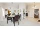 Bright dining area with chandelier, white walls, and open layout to kitchen and living spaces at 1528 Tonada Way, Las Vegas, NV 89117