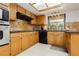 Well-equipped kitchen with stainless steel appliances and black countertops at 1528 Tonada Way, Las Vegas, NV 89117