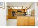 Spacious kitchen with wood cabinets and stainless steel microwave and oven at 1528 Tonada Way, Las Vegas, NV 89117
