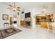 Open-concept living area featuring a fireplace and adjacent kitchen at 1528 Tonada Way, Las Vegas, NV 89117