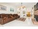 Spacious living room with tile floors, a brick fireplace, and comfortable leather seating at 1528 Tonada Way, Las Vegas, NV 89117