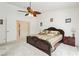 Comfortable main bedroom with neutral tones, ceiling fan, and ensuite bathroom access at 1528 Tonada Way, Las Vegas, NV 89117