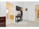 Light-filled main bedroom featuring mounted TV, adjacent bathroom, and a walk-in closet at 1528 Tonada Way, Las Vegas, NV 89117