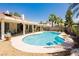 Backyard view of sparkling pool with lush landscaping and covered patio at 1528 Tonada Way, Las Vegas, NV 89117