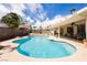 Inviting backyard pool with mature landscaping and covered patio area at 1528 Tonada Way, Las Vegas, NV 89117