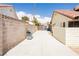 Spacious side yard with a grill, paved area, and access gate, perfect for outdoor activities at 1528 Tonada Way, Las Vegas, NV 89117