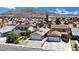 An aerial view showing the home and surrounding neighborhood with mountain views in the background at 1676 Divinity St, Las Vegas, NV 89142