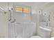 Bathroom featuring a walk-in bathtub, grab bars, and tile surround at 1676 Divinity St, Las Vegas, NV 89142