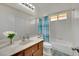 Bright bathroom with a clean, tiled shower, spacious vanity, and decorative blue shower curtain at 1676 Divinity St, Las Vegas, NV 89142