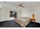 Comfortable bedroom with sliding glass door to backyard patio and ceiling fan at 1676 Divinity St, Las Vegas, NV 89142
