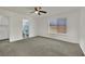 Bedroom featuring neutral carpet, a ceiling fan, and an ensuite bathroom at 1676 Divinity St, Las Vegas, NV 89142