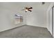 Bedroom featuring neutral carpet, ceiling fan, a window and white walls at 1676 Divinity St, Las Vegas, NV 89142